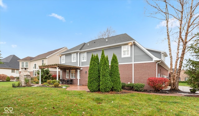 back of property with a patio area, brick siding, a yard, and a pergola