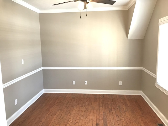 empty room featuring visible vents, baseboards, wood finished floors, and ornamental molding