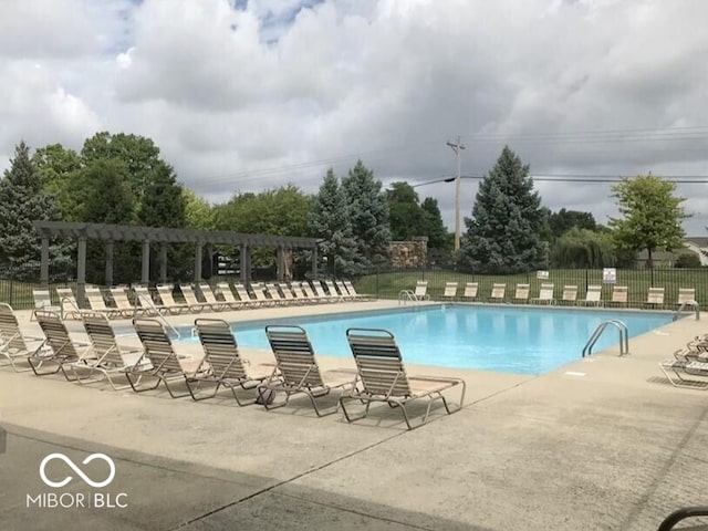 community pool with a pergola, fence, and a patio