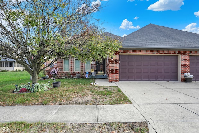 view of front of home featuring a front yard and a garage