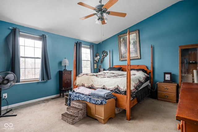 bedroom with carpet flooring, ceiling fan, lofted ceiling, and multiple windows