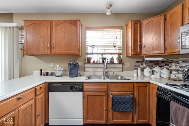 kitchen with stove, white dishwasher, and sink