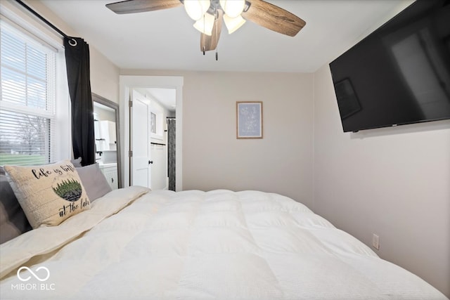 bedroom with ensuite bath and ceiling fan