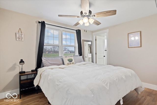 bedroom featuring dark hardwood / wood-style flooring and ceiling fan