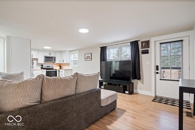 living room featuring light hardwood / wood-style flooring and a wealth of natural light