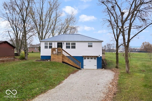 view of front of house with a garage and a front lawn