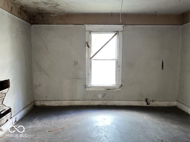 1210 N Rural St, Indianapolis, IN 46201 - unfurnished room featuring healthy amount of natural light and unfinished concrete flooring