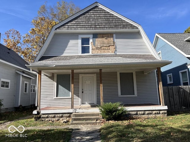 1210 N Rural St, Indianapolis, IN 46201 - colonial inspired home featuring a gambrel roof, a porch, a shingled roof, and fence