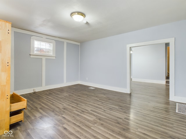 unfurnished room with hardwood / wood-style floors