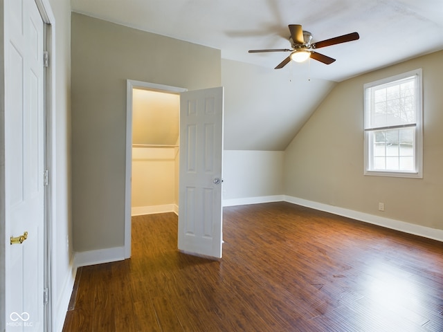 bonus room with ceiling fan, dark wood-type flooring, and lofted ceiling