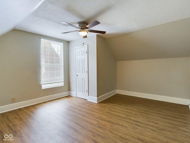 bonus room featuring ceiling fan, dark wood-type flooring, and vaulted ceiling