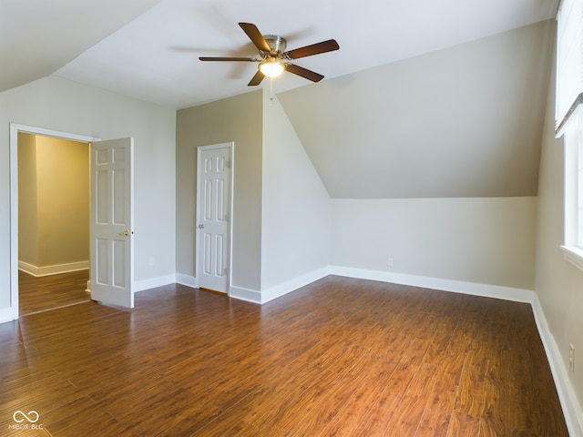 bonus room featuring ceiling fan, a healthy amount of sunlight, lofted ceiling, and dark wood-type flooring