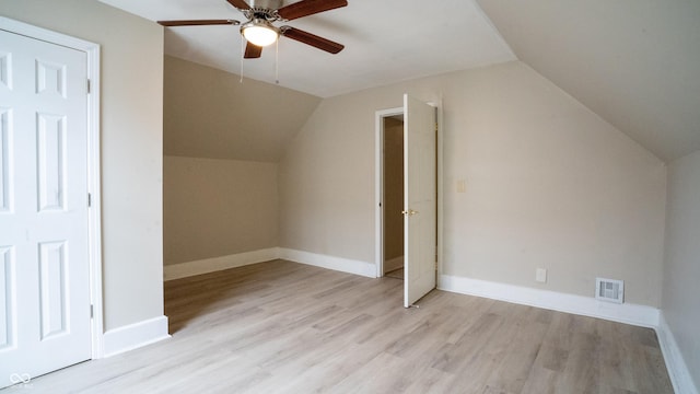 bonus room featuring lofted ceiling, visible vents, and wood finished floors