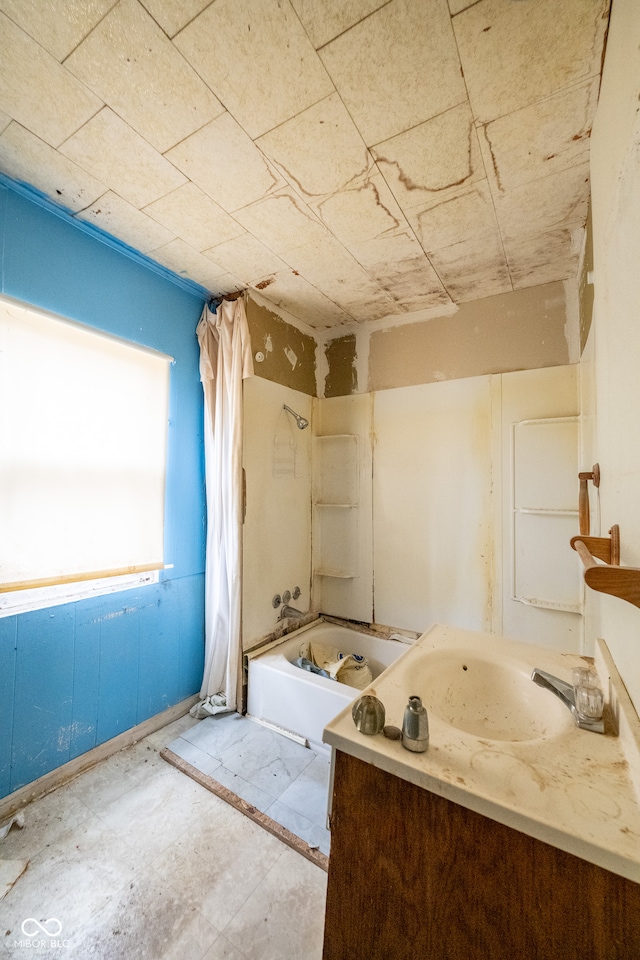 bathroom featuring shower / bath combo and vanity