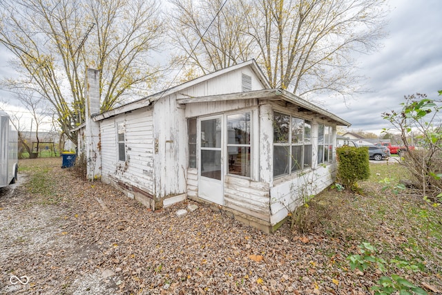 view of side of property featuring a sunroom