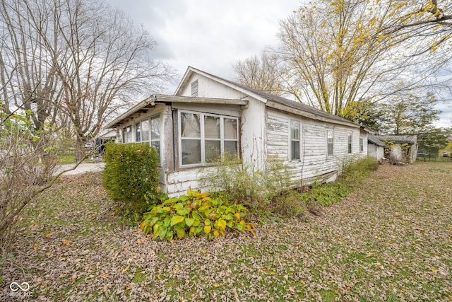 view of property exterior featuring a sunroom