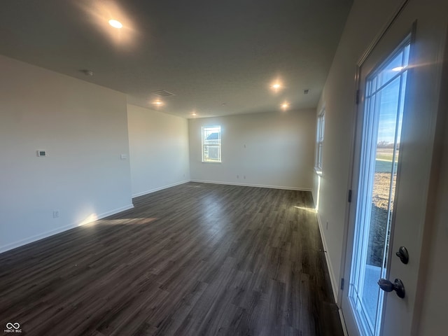 unfurnished room with dark wood-type flooring