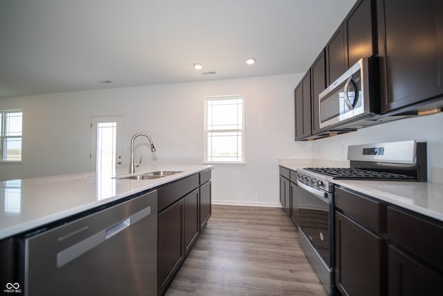 7904 Magnolia St, New Palestine, IN 46163 - kitchen with stainless steel appliances, a sink, light countertops, wood finished floors, and recessed lighting