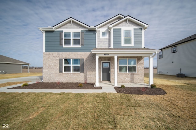 craftsman-style home featuring a front yard and central air condition unit