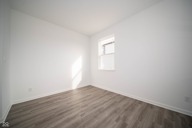 7904 Magnolia St, New Palestine, IN 46163 - spare room featuring dark wood-style floors and baseboards