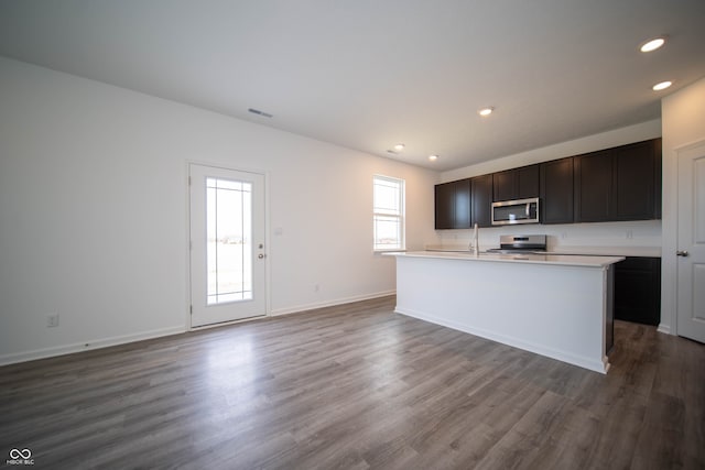 7904 Magnolia St, New Palestine, IN 46163 - kitchen featuring appliances with stainless steel finishes, a sink, dark wood-style flooring, recessed lighting, and light countertops