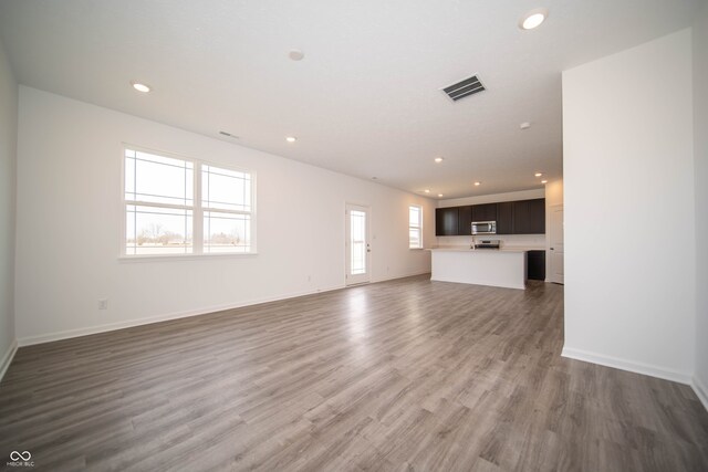 7904 Magnolia St, New Palestine, IN 46163 - unfurnished living room featuring recessed lighting, wood finished floors, and baseboards