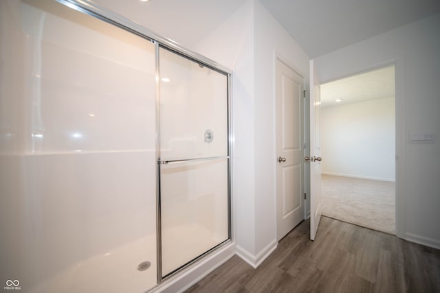7904 Magnolia St, New Palestine, IN 46163 - full bath with wood finished floors, a shower stall, and baseboards