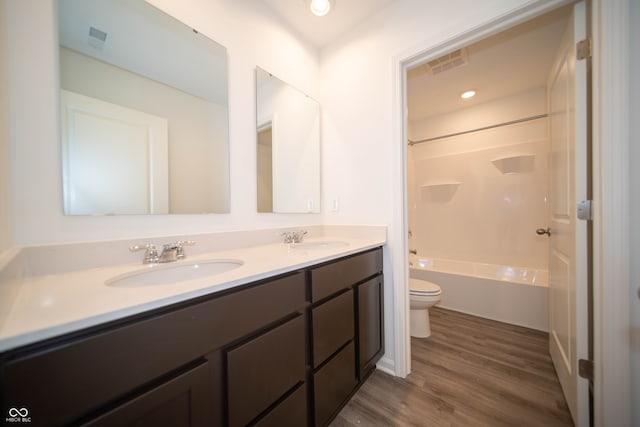 7904 Magnolia St, New Palestine, IN 46163 - bathroom featuring toilet, double vanity, wood finished floors, and shower / bath combination