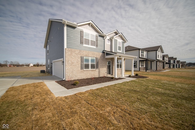 view of front of home featuring a garage and a front lawn