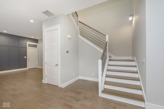 1213 Cottage Ave, Indianapolis, IN 46203 - stairway with wood finished floors, baseboards, and recessed lighting