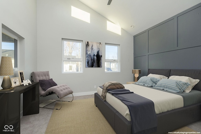 carpeted bedroom featuring high vaulted ceiling