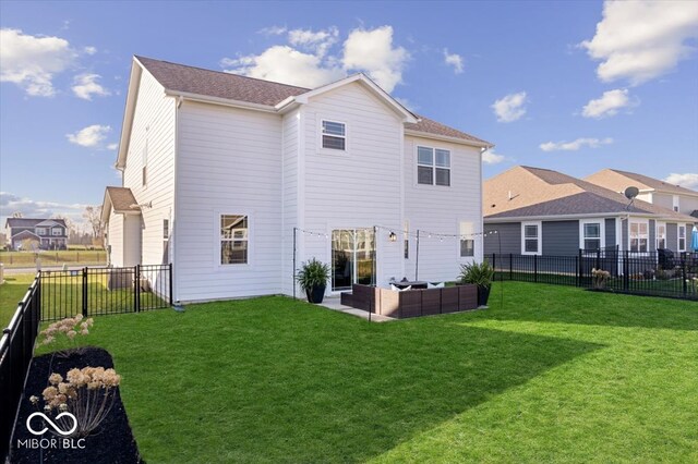 rear view of house with an outdoor living space and a yard