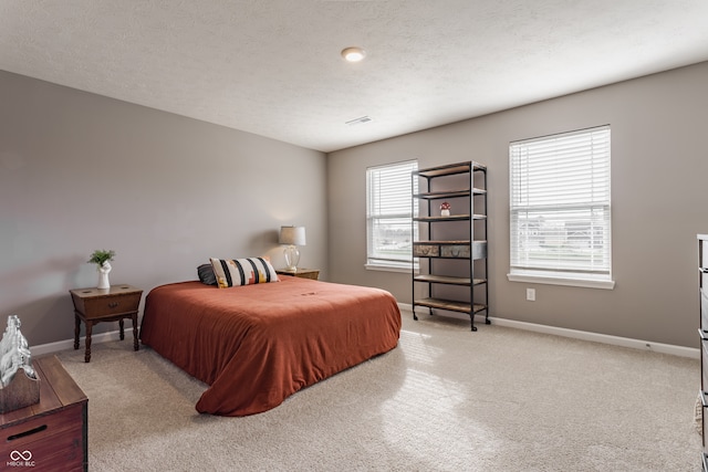 carpeted bedroom featuring a textured ceiling