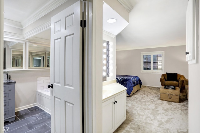 bathroom featuring vanity, a bathtub, and ornamental molding