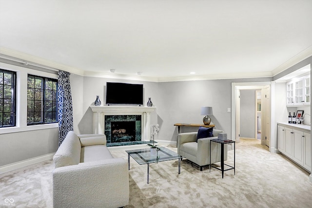 carpeted living room featuring a premium fireplace and crown molding