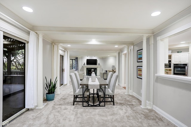 carpeted dining space with crown molding