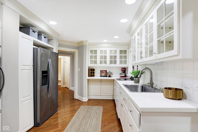 kitchen with stainless steel refrigerator with ice dispenser, dark hardwood / wood-style floors, white cabinetry, and sink