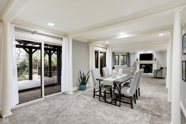 carpeted dining space with beamed ceiling, plenty of natural light, and crown molding