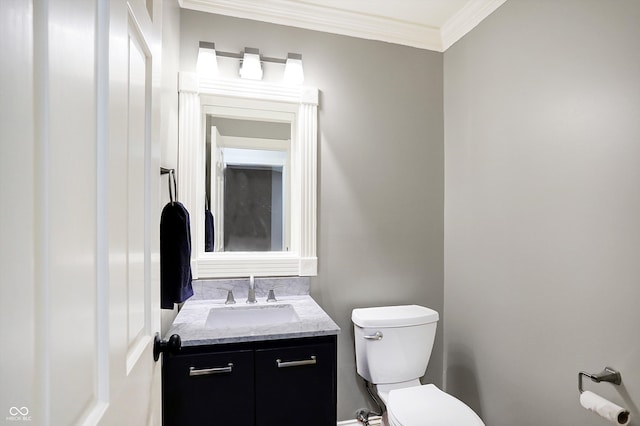 bathroom featuring vanity, toilet, and ornamental molding