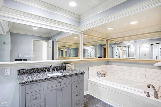 bathroom featuring tile patterned floors, a washtub, crown molding, and vanity