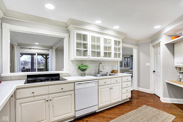 kitchen with dishwasher, black electric cooktop, white cabinets, and sink