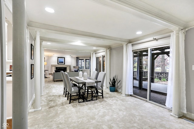 dining room with crown molding and light carpet