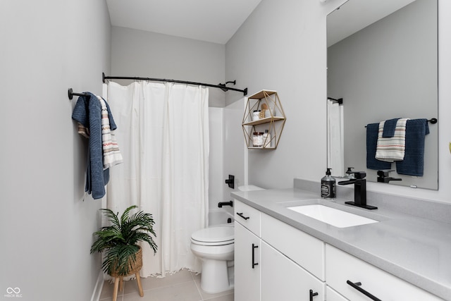 bathroom with toilet, vanity, and tile patterned floors