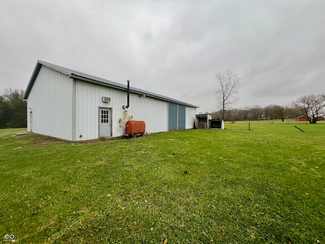 view of property exterior with a yard and an outdoor structure