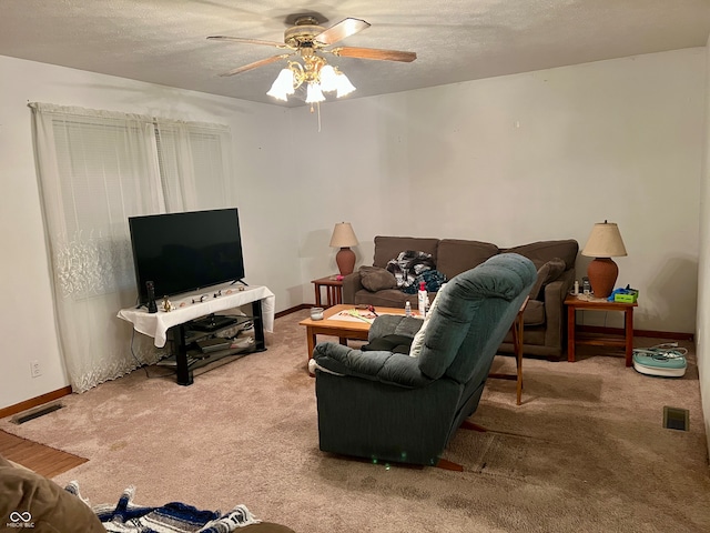 living room with ceiling fan and carpet floors