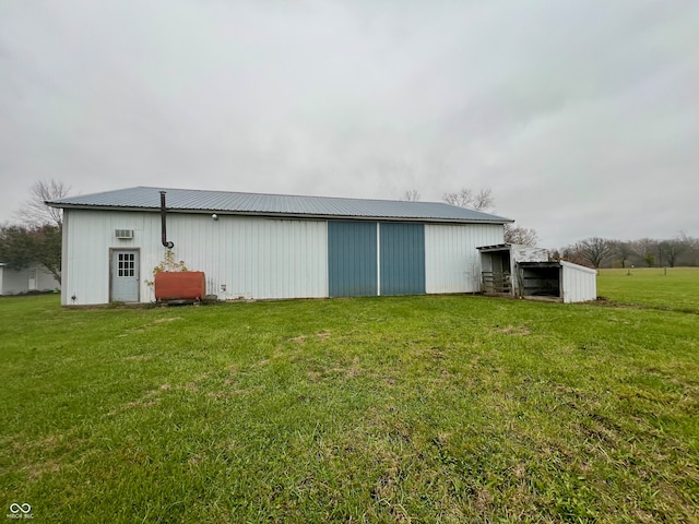 view of outbuilding with a lawn