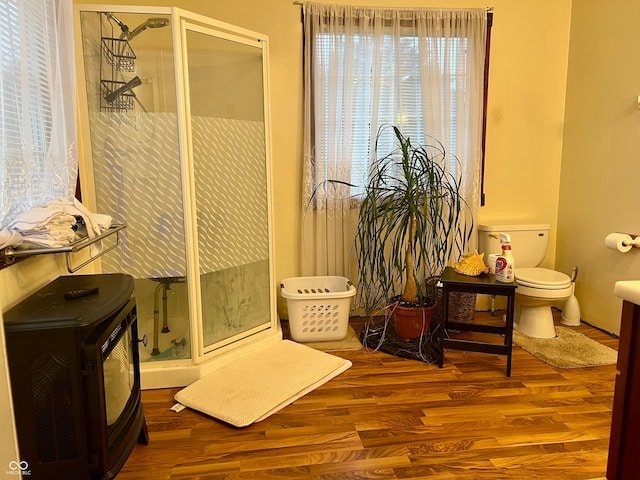 bathroom featuring a wealth of natural light, hardwood / wood-style floors, and walk in shower