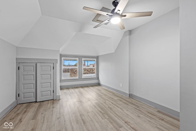 bonus room featuring ceiling fan, light hardwood / wood-style floors, and lofted ceiling