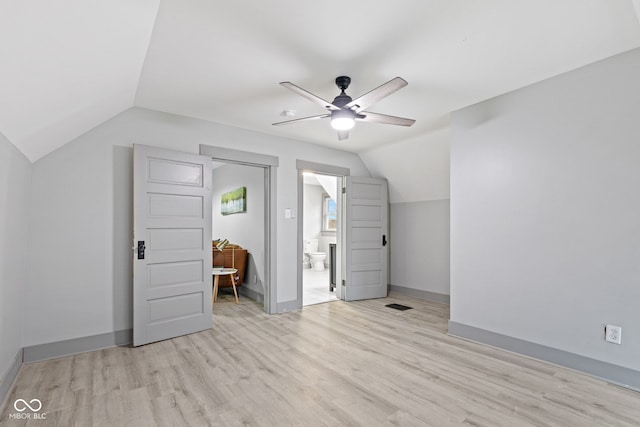 bonus room with light wood-type flooring, vaulted ceiling, and ceiling fan