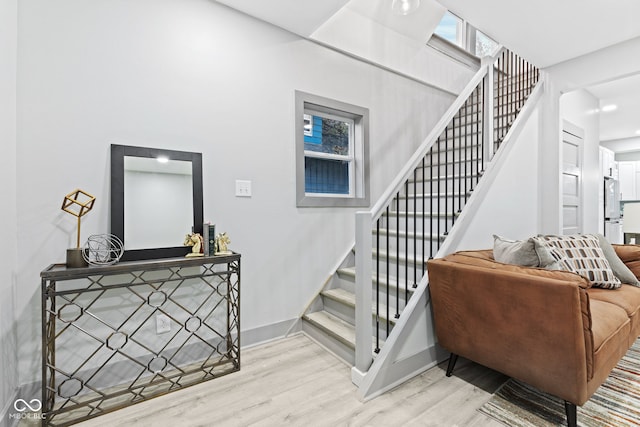 staircase with hardwood / wood-style flooring